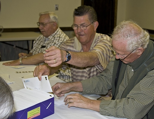 Bob Stimmel, Dick Gray, and Pete King putting their all into labeling envelopes.